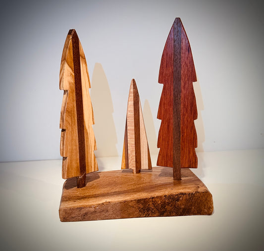 2. Three tree mantel decor. Exotic and domestic wood scene including one striped tree. On hardwood base. Contact us for current available stock