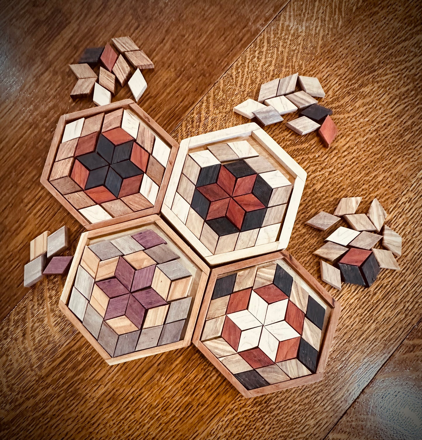 1K.  Creativity Puzzle.   Art Puzzle.   Create your own designs with perfect parallelogram shapes in this puzzle. Exotic woods in 4 species.  Make 27 piece designs in a hexagon.  Comes with several spare pieces in each wood color.