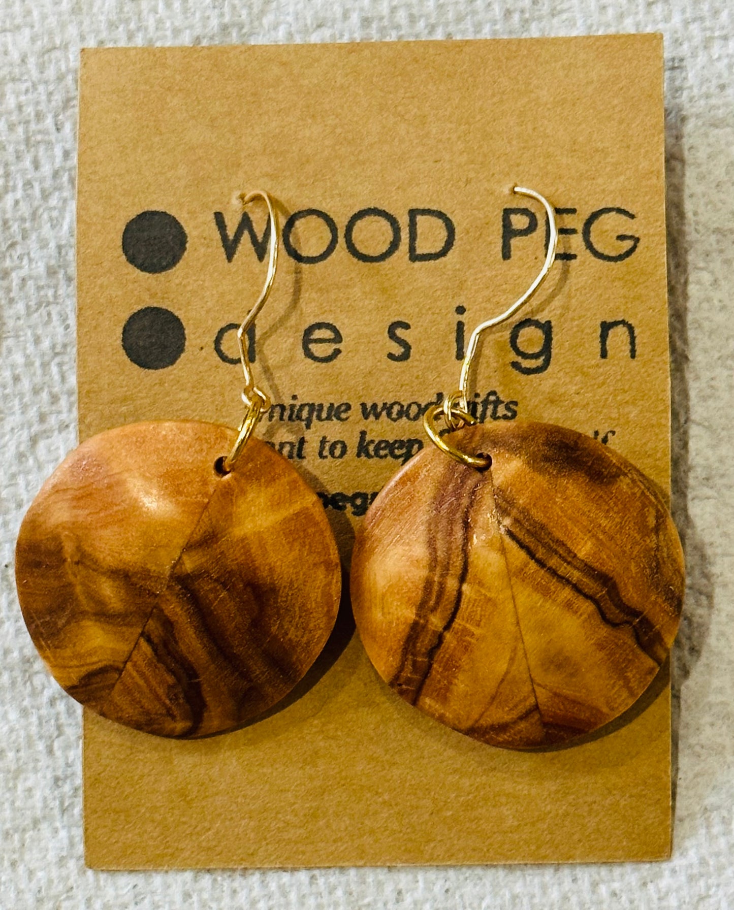 1A.  Custom Earrings.   Bookmatched Olivewood round earrings.