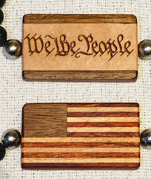 9.   Bracelet.  American Flag Bracelet with “We the People” on reverse.